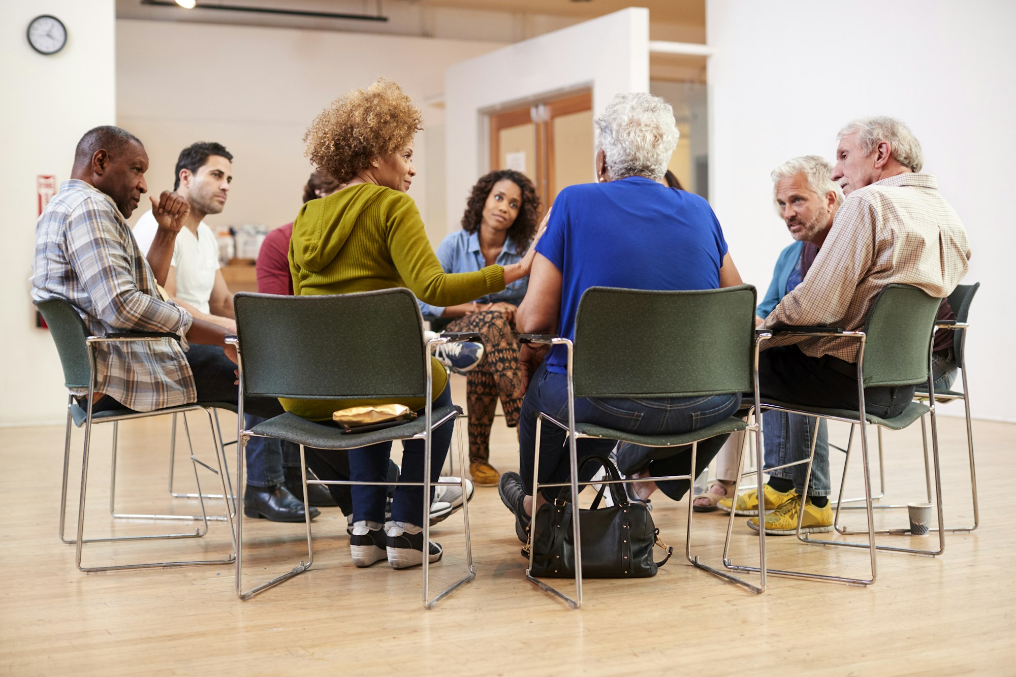 People Attending Self Help Therapy Group Meeting In Community Center